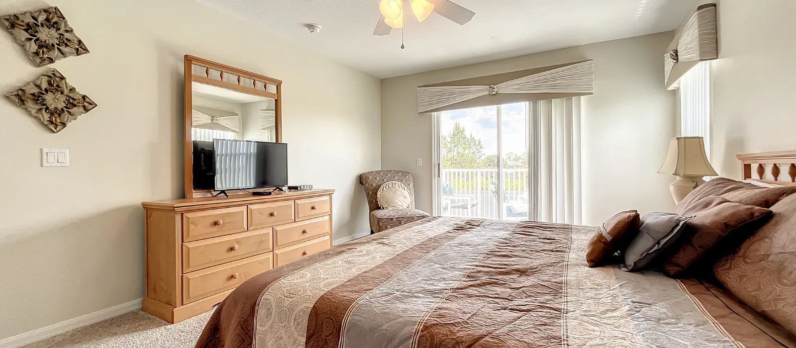 King master suite second view with TV, dresser and balcony doors