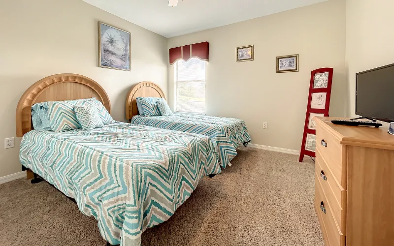 Twin bedroom with chevron bedding and dresser